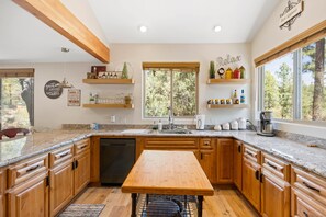 Open and bright kitchen with ample space to visit with friends