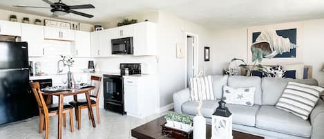 Brand new kitchen with dishwasher and living room furnishings.