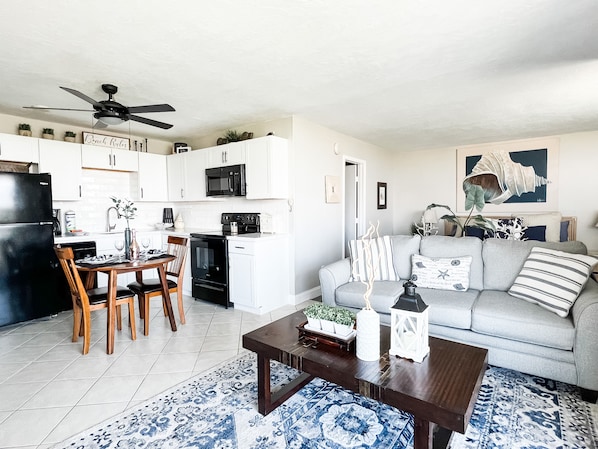 Brand new kitchen with dishwasher and living room furnishings.