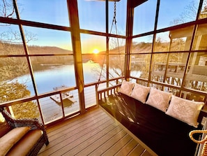 Screened in porch with day bed off primary king room. 