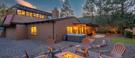 Beautiful backyard with gas firepit, putting green, and hot tub