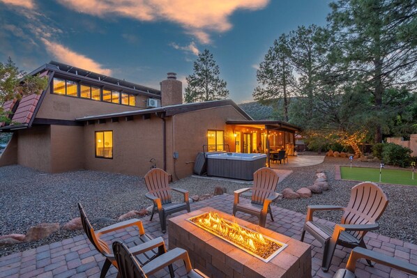 Beautiful backyard with gas firepit, putting green, and hot tub