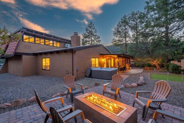 Beautiful backyard with gas firepit, putting green, and hot tub to keep you entertained