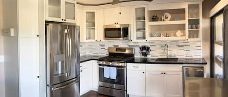 Fully furnished kitchen with cookware, dishes, etc. Eat out or stay in.