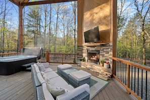 Guests love sitting in the hot tub and enjoying the outdoor fireplace