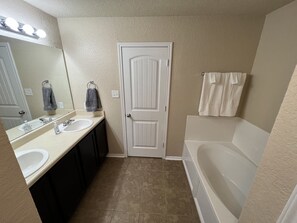 Master bathroom with bathtub and separate shower