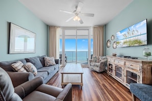 Living area with floor-to-ceiling glass sliders and beach views
