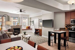 Spacious condo with large dining table and additional high top seating.