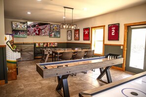 Game room with 5 TVs, air hockey, shuffleboard, foosball, 3 arcades, a multicade, and 5 TVs