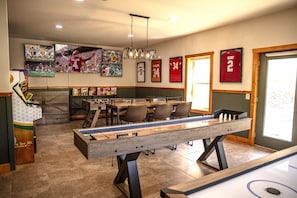 Game room with 5 TVs, air hockey, shuffleboard, foosball, 3 arcades, a multicade, and 5 TVs