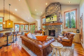 Vaulted Living Room With Statement Stone Gas Fireplace + Luxe Seating