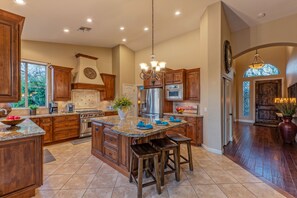 Well stocked kitchen has island seating for sipping your coffee or meals on the run.