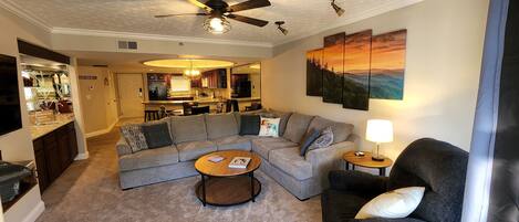 Spacious livingroom with a gas fireplace, sectional, recliner and mountain views