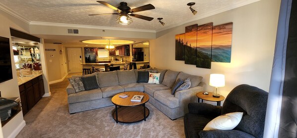 Spacious livingroom with a gas fireplace, sectional, recliner and mountain views