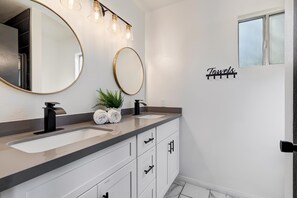 Bathroom with double sinks and rain shower
