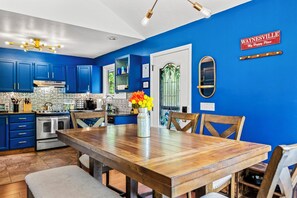 The dining room is awash in natural light and features a counter-height dining table. Use the optional leaves to extend the length for extra guests!
