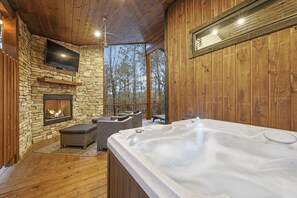 Guests love sitting in the hot tub near the outdoor fireplace.