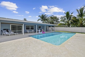 A view of the pool and house from the backyard.