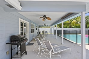 A view of the covered lanai area, with new outdoor grill in foreground.