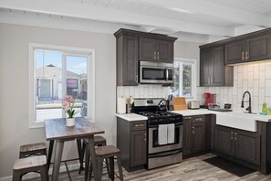 Modern kitchen with dark cabinets and breakfast nook.