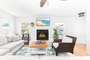 The main living area - located on the ground floor - is bright and cheery, perfect for unwinding after a day at the beach.
                