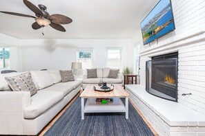 The main living area - located on the ground floor - is bright and cheery, perfect for unwinding after a day at the beach.
                