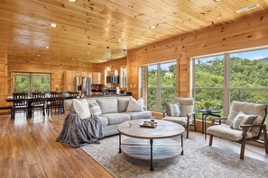 Enjoy the stunning mountain views on the large screened-in patio complete with a fireplace and 70" SmartTV | Eaglebend Cabin by Great Smoky Mountains Cabin Rentals | Sevierville, TN