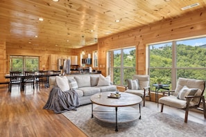 Enjoy the stunning mountain views on the large screened-in patio complete with a fireplace and 70" SmartTV | Eaglebend Cabin by Great Smoky Mountains Cabin Rentals | Sevierville, TN