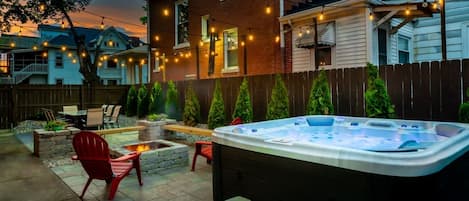 Wow! An urban oasis awaits. Private retreat with hot tub, fire pit, and string lights to set the perfect mood.