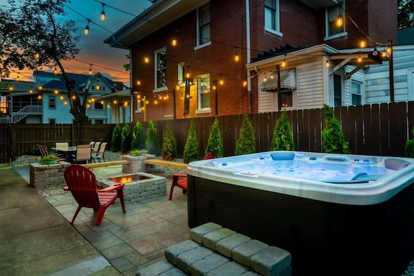 Wow! An urban oasis awaits. Private retreat with hot tub, fire pit, and string lights to set the perfect mood.