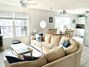 Open concept living, dining and kitchen with large, comfortable sectional sofa.