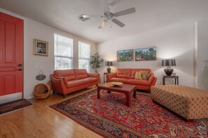 Comfortable open space w/Leather sofa/loveseat huge ottoman & soft oriental rug 