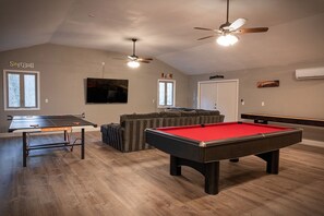 Game room with pool table, ping pong, shuffleboard, sectional, 70 inch Smart TV