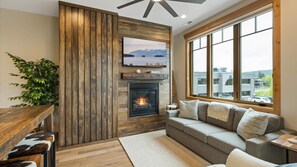 Open concept living room with gas fireplace, luxury American Leather sofa sleeper (no bars and luxury mattress), HDTV with streaming capabilities, and views of Big Mountain