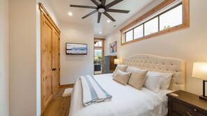 Master suite includes luxury king mattress and linens, large closet, HDTV with streaming capabilities, ensuite bathroom, access to deck with mountain views.