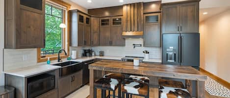 Fully stocked kitchen with top of the line appliances, breakfast bar seating for 6, and convection stove top.