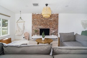 (Outdated Photo) Decorative Wood Fireplace now has a 55" Smart TV