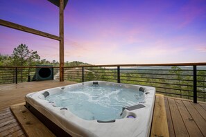Serene Soak: Submerge in tranquility in the 8-person hot tub, offering an uninterrupted view that calms the soul as the water soothes the body. 