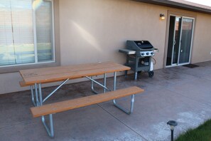 Back patio with picnic table and propane grill