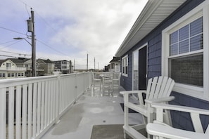 Front deck with outdoor furniture. Adirondack Chairs and Table and chairs