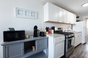 Prepare meals like a pro in our well-stocked kitchen, featuring a variety of utensils that blend practicality and a visually pleasing aesthetic.