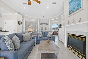Open concept living room and kitchen with sofa and loveseat. 