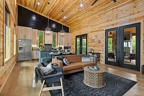 Cozy cabin retreat for two: Enjoy the seamless blend of dining, living, and kitchen spaces in an open, inviting layout.