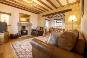 Threp'nybit Cottage, near Helmsley: Sitting room with wood burning stove