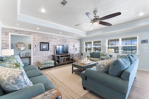 Enjoy family time in this huge living room with plenty of comfortable seating.