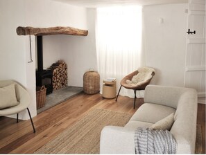 Cosy sitting room with log burner.