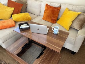 The den includes a convertible coffee table into full table to eat or work 