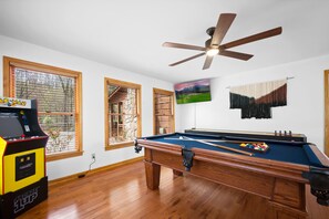 Game Room With A Pool Table, Shuffleboard Table, and Multicade with PAC-MAN