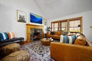 Cozy Living Room With Leather Couches and a Large Stone Fireplace 