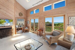 Bask in the unlimited natural light of the open Living Area with high ceilings and cozy furniture.